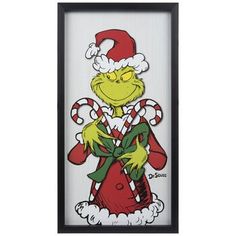 an image of the grinch with candy canes in his hand and santa's hat