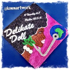 a decorated graduation cap with the words delibeate doll on it