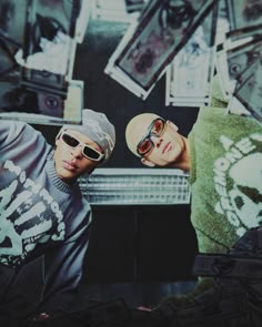 two young men wearing sunglasses are standing next to each other in front of a mirror