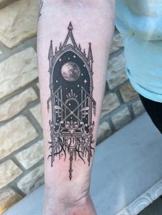 a black and white tattoo on the arm of a person with a clock in it