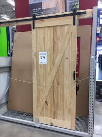 an open wooden door on display in a store