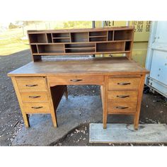 an old wooden desk with two drawers and a bookcase on it's side