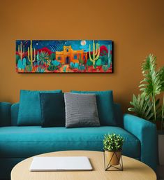 a living room with a blue couch and potted plants on the table in front of it