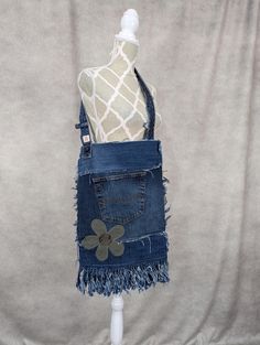 a mannequin wearing a denim skirt with flowers on the front and back pockets