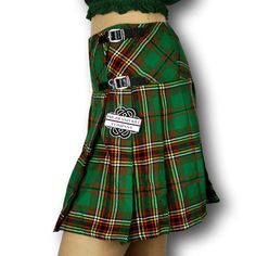 The women's tartan billie skirt is a stylish and versatile garment that combines classic Scottish heritage with contemporary fashion. Made from high-quality tartan fabric, the billie skirt showcases a beautiful array of colors and patterns, reflecting the rich tradition of Scottish plaids. The skirt features a flattering A-line silhouette that flares out from the waist, creating a feminine and elegant look. It typically falls just above or below the knee, offering a modest yet fashionable length Irish Kilt, Tartan Sash, Crisp White Blouse, Checkered Skirt, Scottish Plaid, Concert Outfits, Tartan Fabric, Scottish Heritage, Green Skirt