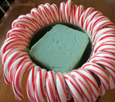 there is a cake with green frosting and candy canes