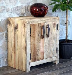 a potted plant sitting on top of a wooden cabinet