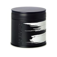 a black canister with white paint on it