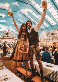 a man and woman holding up beer glasses