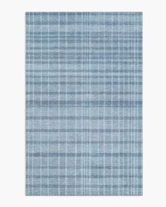 a light blue rug with plaid pattern on it