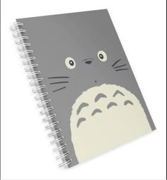 a spiral notebook with an image of a cat on the front and back cover, which has eyes wide open