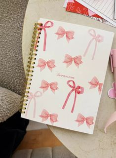 an open notebook with pink bows on it