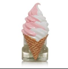 an ice cream cone with pink and white icing in a glass bottle on a white background