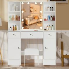 a white vanity with lights on it in a living room next to a couch and chair