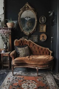 a living room with a couch, mirror and other antique items on the wall in front of it