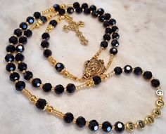 Stunning black and gold Rosary beads, Created with 8mm glass beads, Gold plated medal and cross with stainless steel cord, #Car Bracelet, follow the link (refer to photos). https://www.etsy.com/au/listing/1089430299/hanging-rosary-beadspersonalised-car?click_key=4b61c937486b92293e5330713248d7c273fcfbac%3A1089430299&click_sum=ca4d9f67&ref=shop_home_active_10&pro=1&sts=1 #Measures 53cm from the bottom tip of the cross to the top half of the rosary  18cm drop 72cm necklace (depending on how many na Black Rosary Necklace, Catholic Necklace, Gold Rosary, Rosary Catholic, Rosary Beads, Prayer Beads, Family Name, Shop Home, Gifts For Father