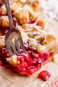 a close up of a fork in a piece of pie with cranberry sauce