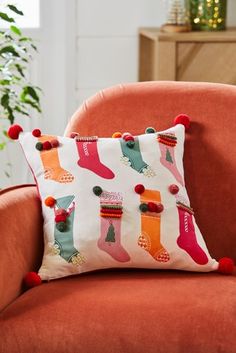 a red chair with a christmas stocking pillow on it