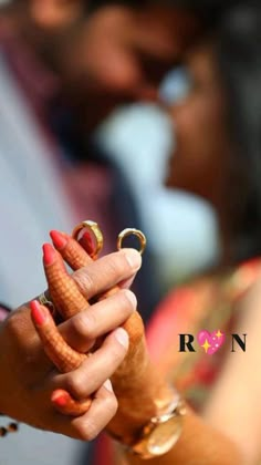 a man and woman holding hands with rings on their fingers