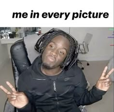 a man with dreadlocks sitting in a chair holding his hands up to the side