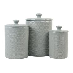 three grey canisters with lids and handles