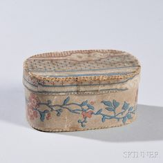 an old wooden box with floral designs on the lid and bottom, sitting against a white background