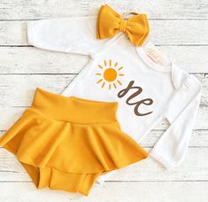 You may choose: ~Sun "One" bodysuit as shown. Personalization optional. ~Adorable skirted bummie as shown. Created here in our studio. ~Matching bow/headband All items are hand made with love. The outfit runs true to size so please order current clothing size for a perfect fit. Christi Creations - creating happy moments one bummie at a time Check out other items in our shop! http://www.christicreations.etsy.com Copyright © 2008 by ChristiCreationsLLC. All rights reserved. This design or any port Sunshine Birthday Photoshoot, Sunshine First Birthday Photoshoot, First Trip Around The Sun Outfit, Sunny First Birthday, One Year Around The Sun Birthday Girl, Sun Smash Cake, Sunshine 1st Birthday Party Girl, One Sunshine Birthday Shirt