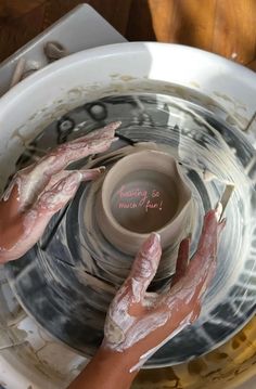 two hands that are on a pottery wheel