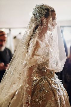 a woman in a wedding dress with a veil on her head