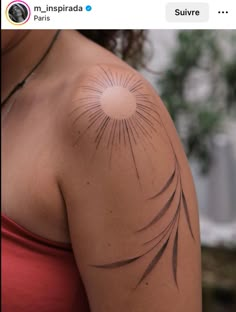 a woman with a sun tattoo on her arm