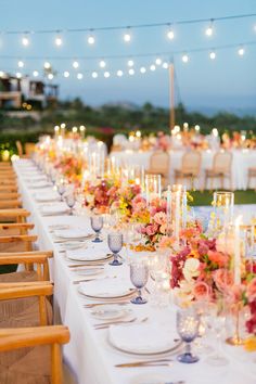 a long table is set with flowers and candles