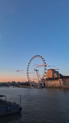 a large ferris wheel sitting on top of a river