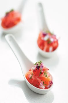 three spoons filled with different types of food