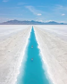 a long line of blue water in the middle of nowhere