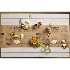 a table topped with lots of food and condiments on top of a wooden board