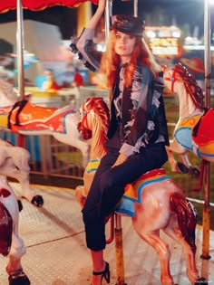 a woman sitting on top of a merry go round