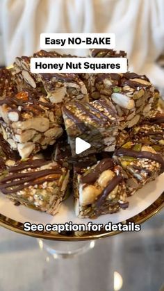 a white plate topped with pieces of chocolate and nuts on top of a glass table