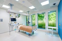 an empty hospital room with medical equipment in it