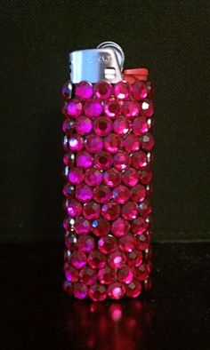 a flask covered in pink and red jewels