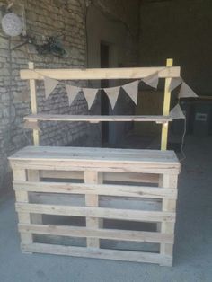 a bench made out of wooden pallets with bunting