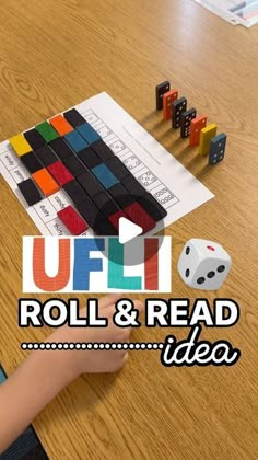 a child is playing with some dices and blocks on the table in front of them