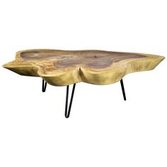 a wooden table with black legs and a large piece of wood on it's side