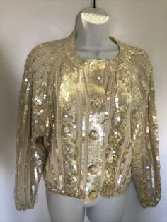 VTG 80's "Destinee" Cardigan Sequin Long Sleeve ivory Wool Acrylic Blend Sweater. Irridescent sequins. Snap front and covered buttons with sequins. Tag says small but seems larger. Check measurements. Gold Cardigan For Winter Party, Gold Cardigan For Fall Party, Elegant Gold Sweater For Winter, Elegant Gold Winter Sweater, Fitted Beige Sweater For Party, Fitted Beige Party Sweater, Fitted Gold Cardigan For Fall, Fitted Gold Sweater For Spring, Cream Formal Cardigan For Fall