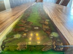 the table is made out of wood and has moss growing on it, along with other plants