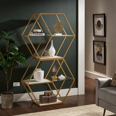 a modern shelving unit in a living room with green walls and wood flooring