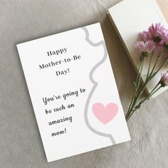 a mother's day card next to some flowers