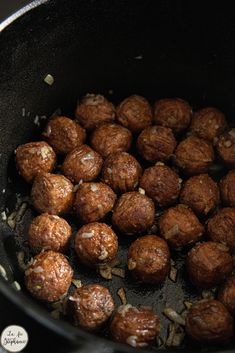 some meatballs are cooking in a pan on the stove top and is ready to be cooked