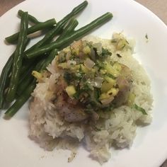 a white plate topped with rice and green beans