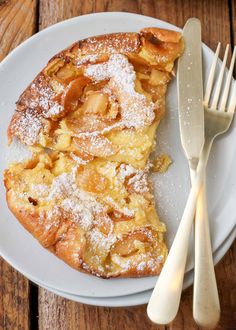 a white plate topped with pastry next to a fork