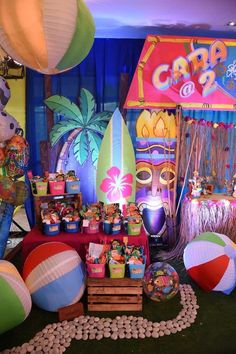 there are many colorful items on display at this party, including beach balls and paper lanterns